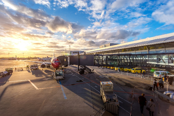 A red airplane against a blue sky, representing the excitement and urgency of international travel.