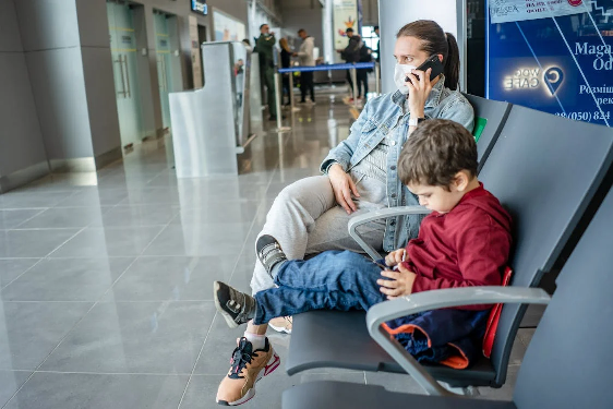 A mom and son waiting at the airport