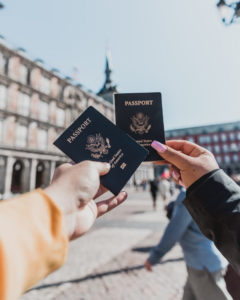 Two people holding their passports