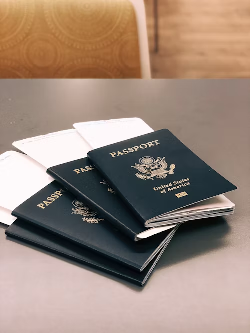 Four passports with tickets inside them