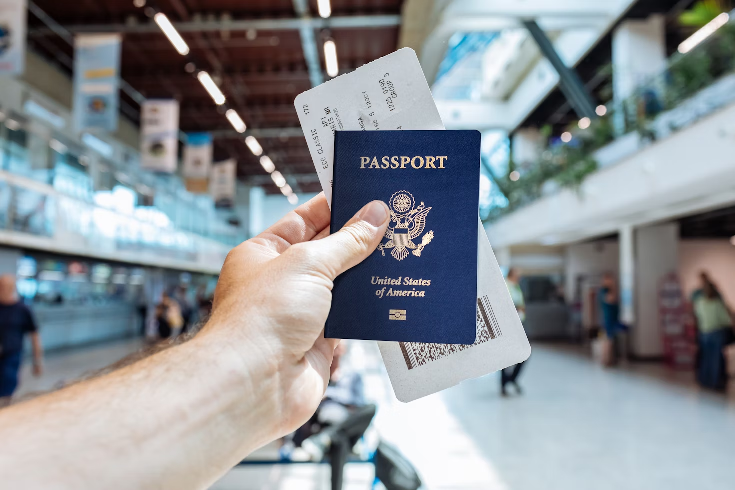 A man holding his passport and ticket