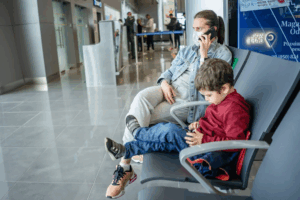 A mom and son waiting at the airport