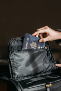 Person putting a passport in a bag