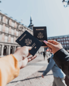 2 people holding passports